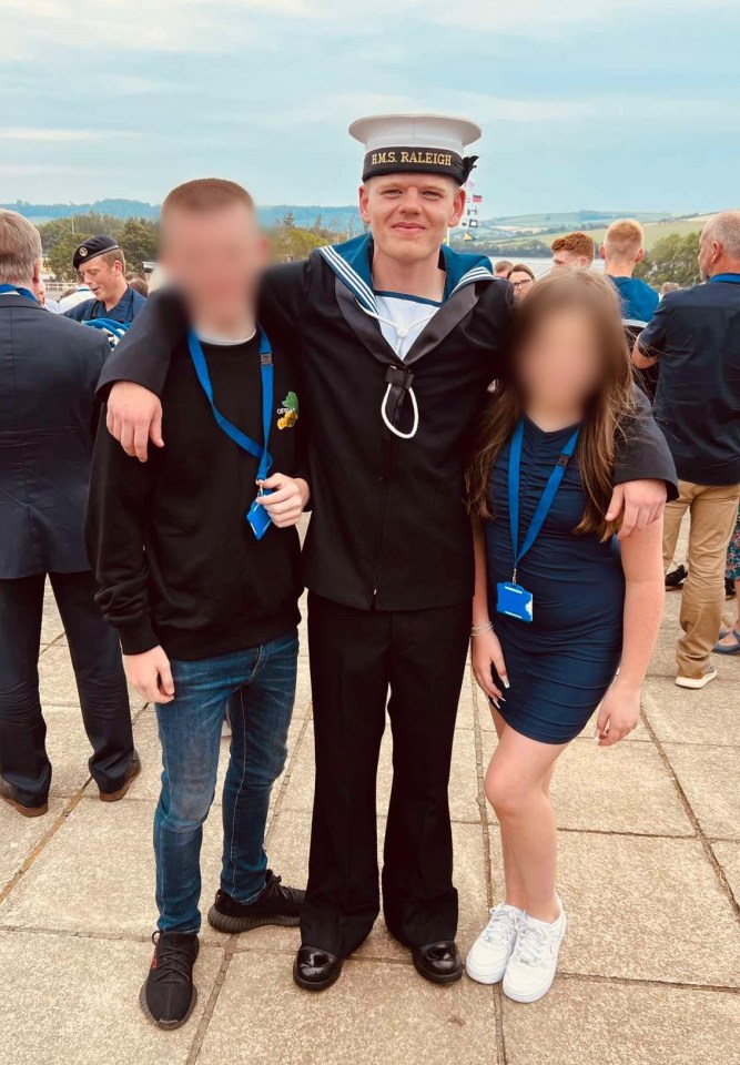 A Royal Navy sailor poses for a photo with his siblings.
