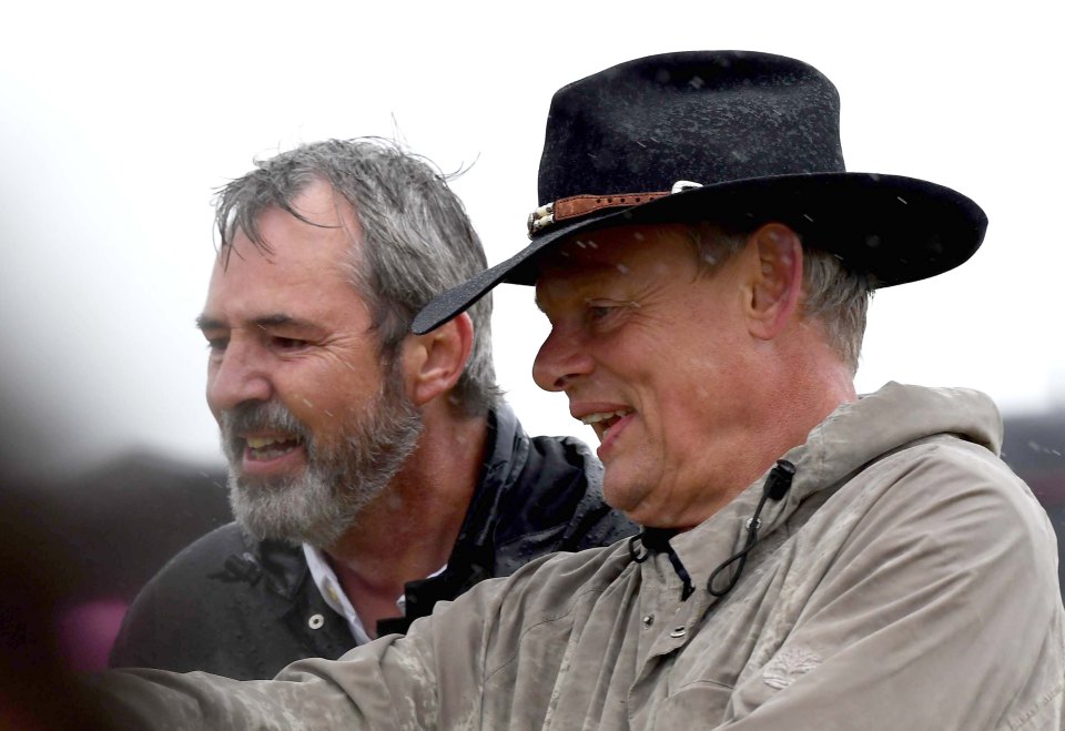 Neil Morrissey and Martin Clunes judging a dog contest in the rain.