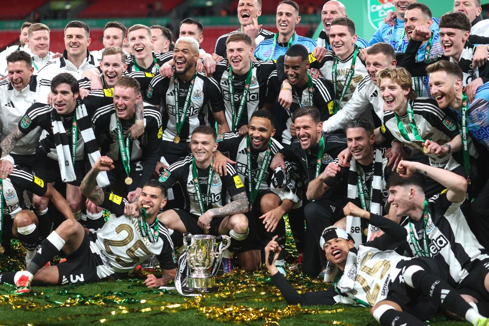 Newcastle United players celebrating a victory with a trophy.