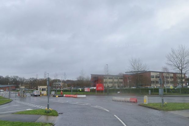 An image collage containing 1 images, Image 1 shows Entrance to a building complex on an overcast day
