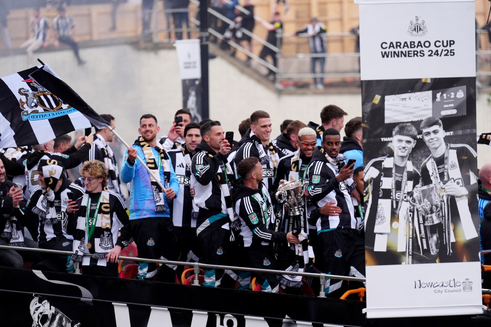 Newcastle United players celebrating their Carabao Cup victory on an open-top bus.