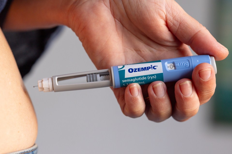 Person injecting Ozempic.