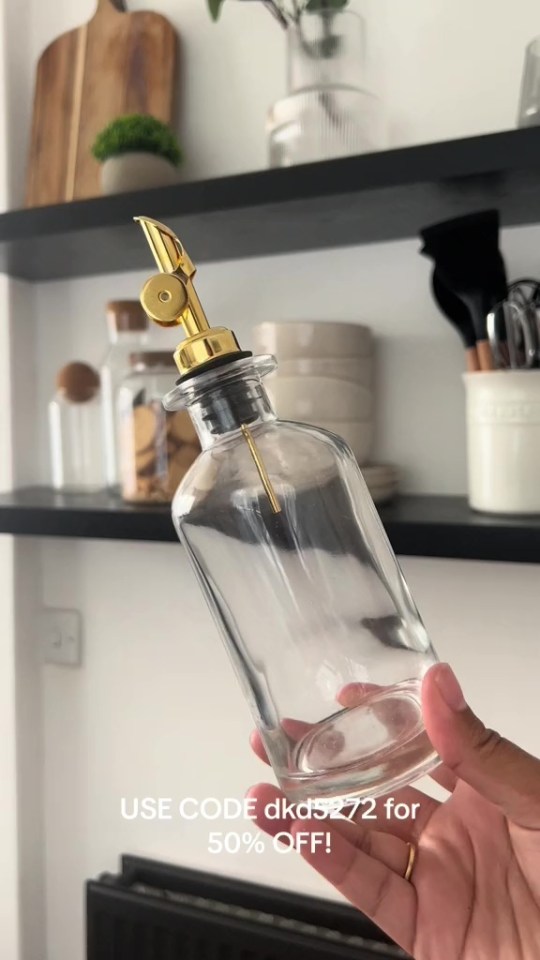 Glass oil dispenser with gold top.