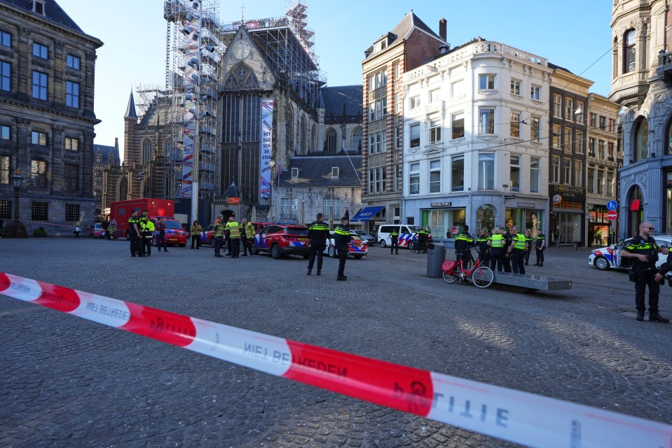Police officers at a crime scene near Amsterdam's Dam Square.