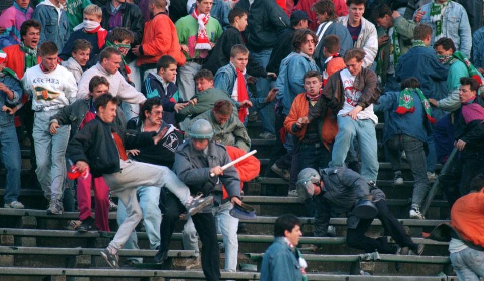 Polish police officers trying to restore order among fighting soccer fans.