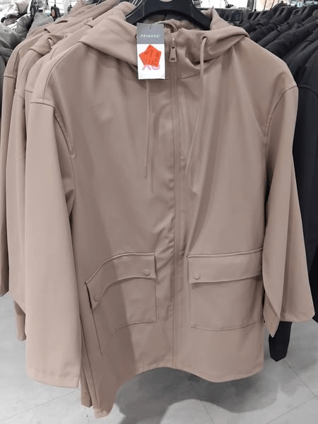 Beige hooded raincoat on display at Primark.