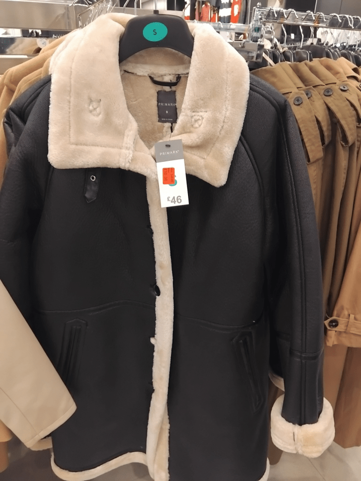 Black Primark shearling coat with cream collar and cuffs.