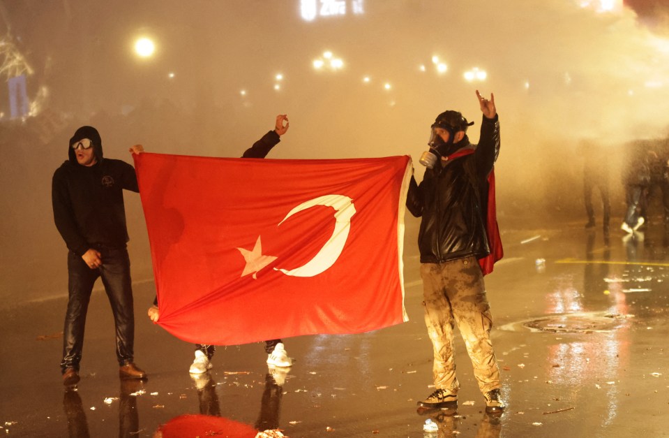 Protesters holding a Turkish flag during a demonstration.