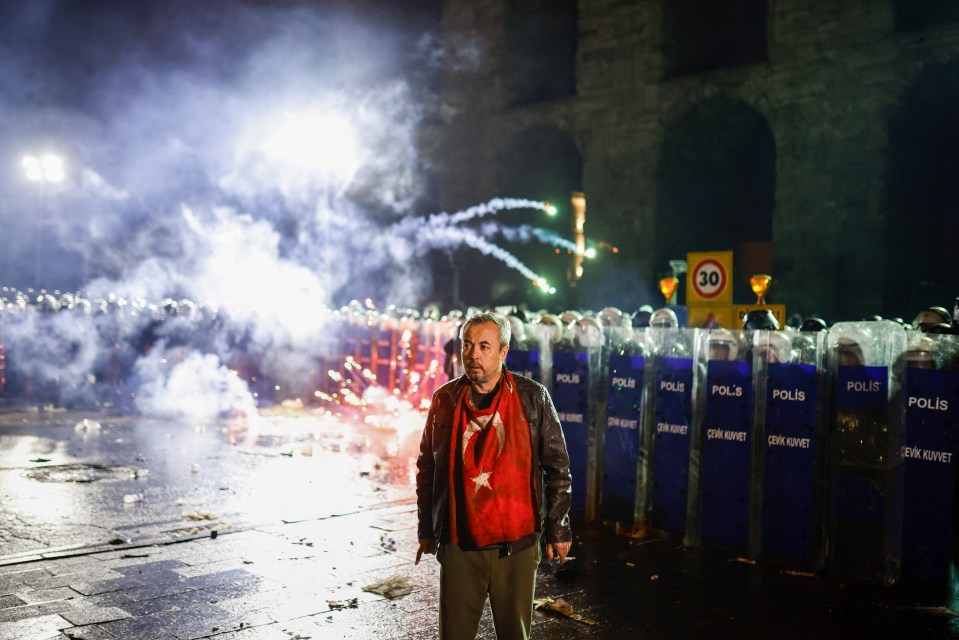Protestor in front of Turkish riot police during a rally.