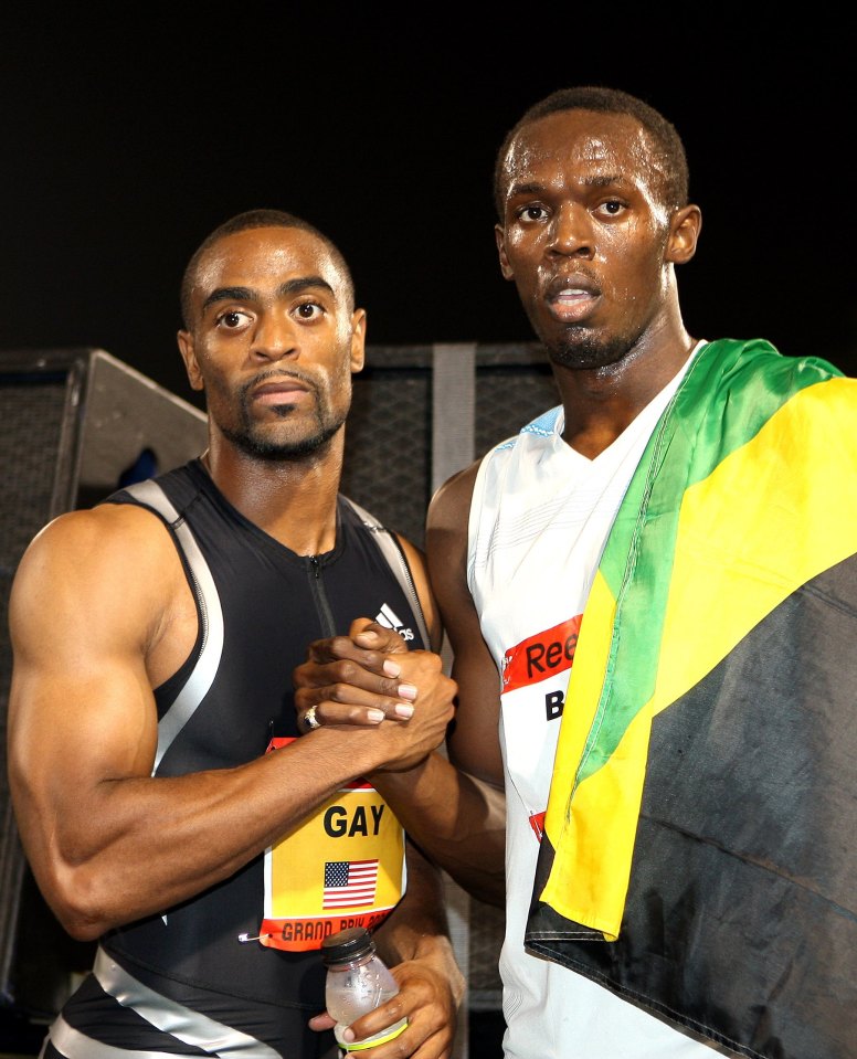 Usain Bolt and Tyson Gay shaking hands after a race.