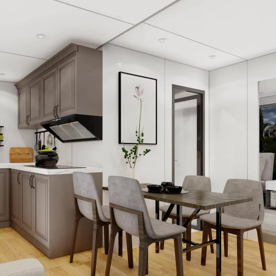 Illustration of a small, foldable house's interior, showing a kitchen and dining area.