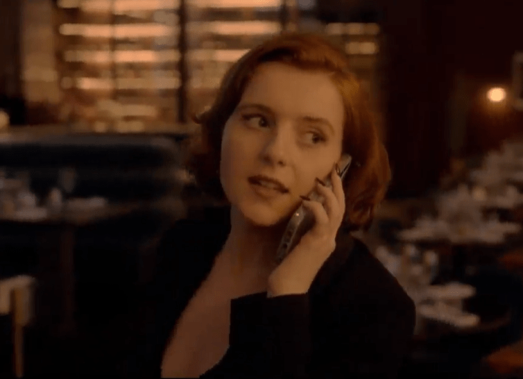 Woman on phone call in restaurant.