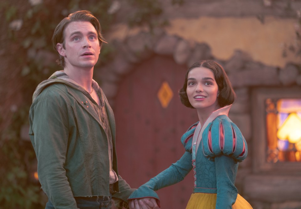 Film still of Rachel Zegler as Snow White and Andrew Burnap as Jonathan from the movie *Snow White*.