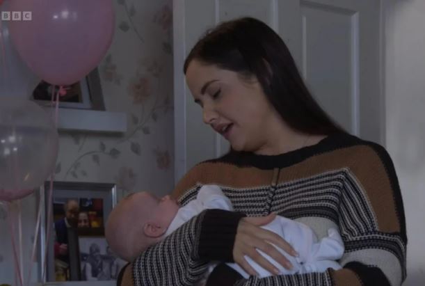 Woman holding a baby.
