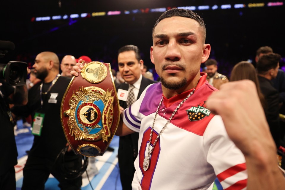 Teofimo Lopez celebrating his victory and holding the WBO junior welterweight title belt.