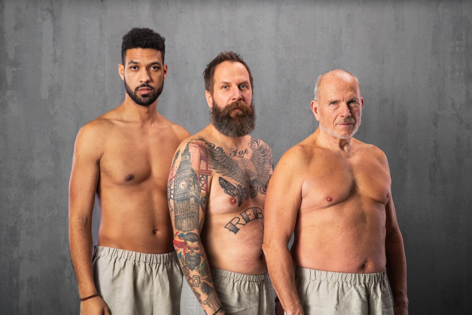 Three shirtless men of different ages and ethnicities stand together.