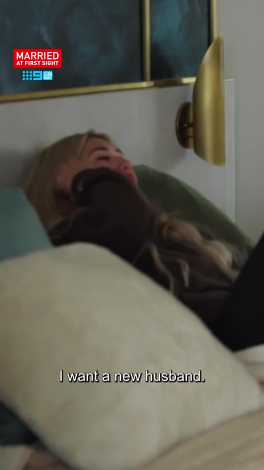Screenshot of a woman lying in bed saying, "I want a new husband."  The Married at First Sight logo is visible in the upper left corner.