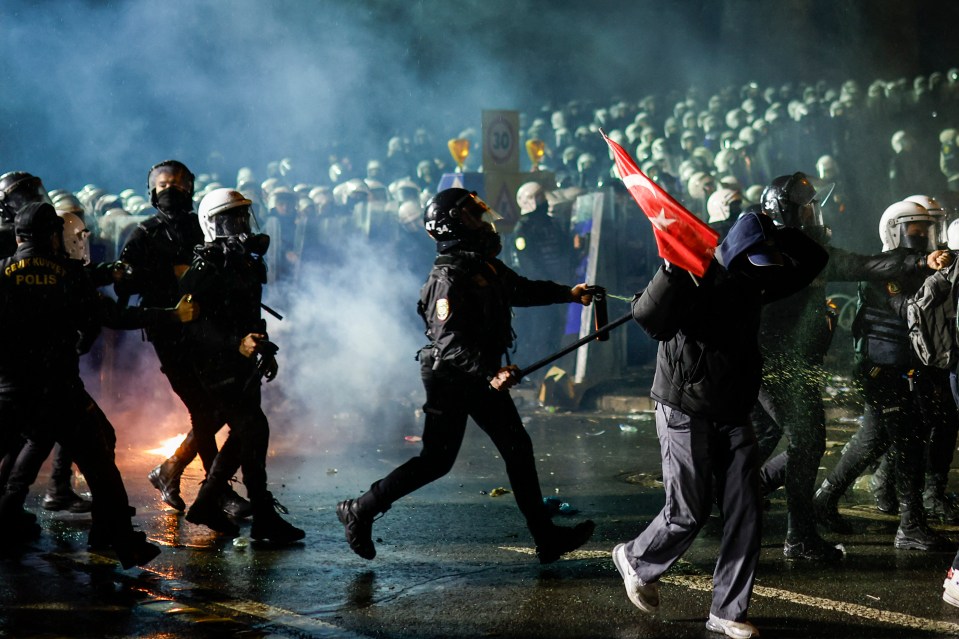 Riot police using pepper spray against protesters in Istanbul.