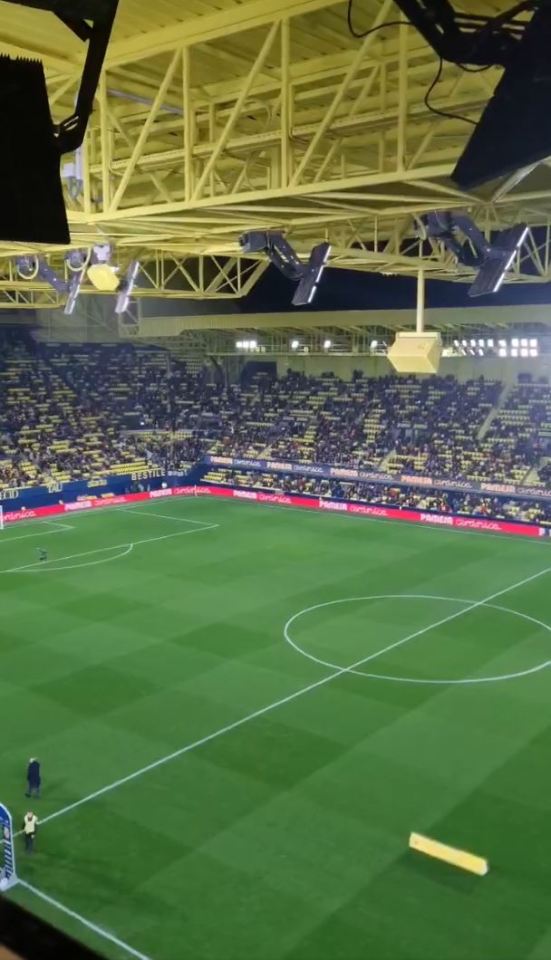 A soccer stadium mostly filled with spectators.