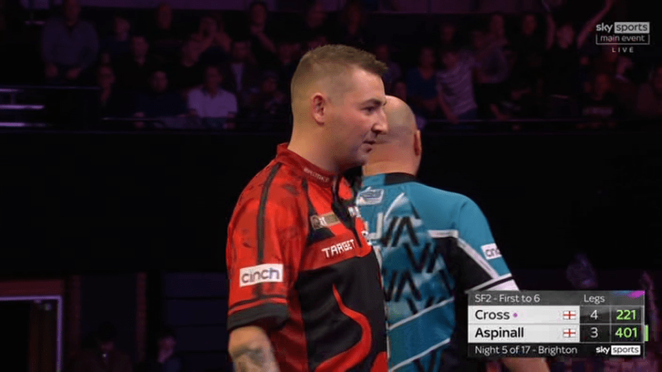 Darts players Cross and Aspinall during a match.