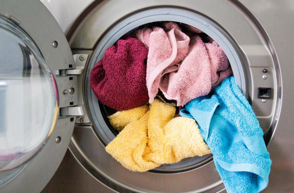 Colorful towels in a washing machine.