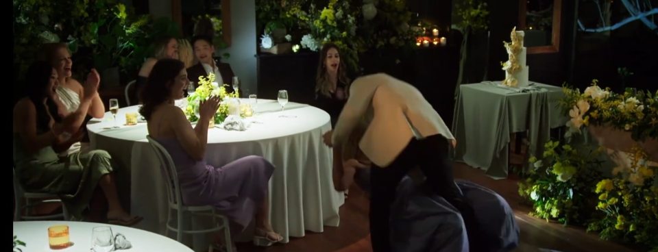 A groom dramatically apologizes to his bride at their wedding reception.
