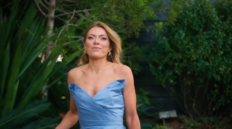 A woman in a blue strapless dress.