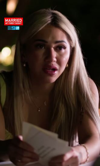 A shocked woman reads a letter.