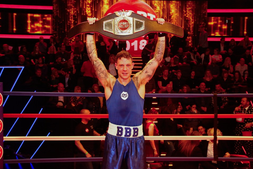 Wayne Bridge holding up a championship belt after winning a celebrity boxing match for Sport Relief.