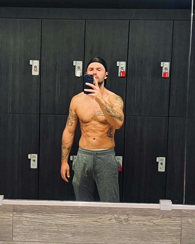 Man taking a selfie in a gym locker room.