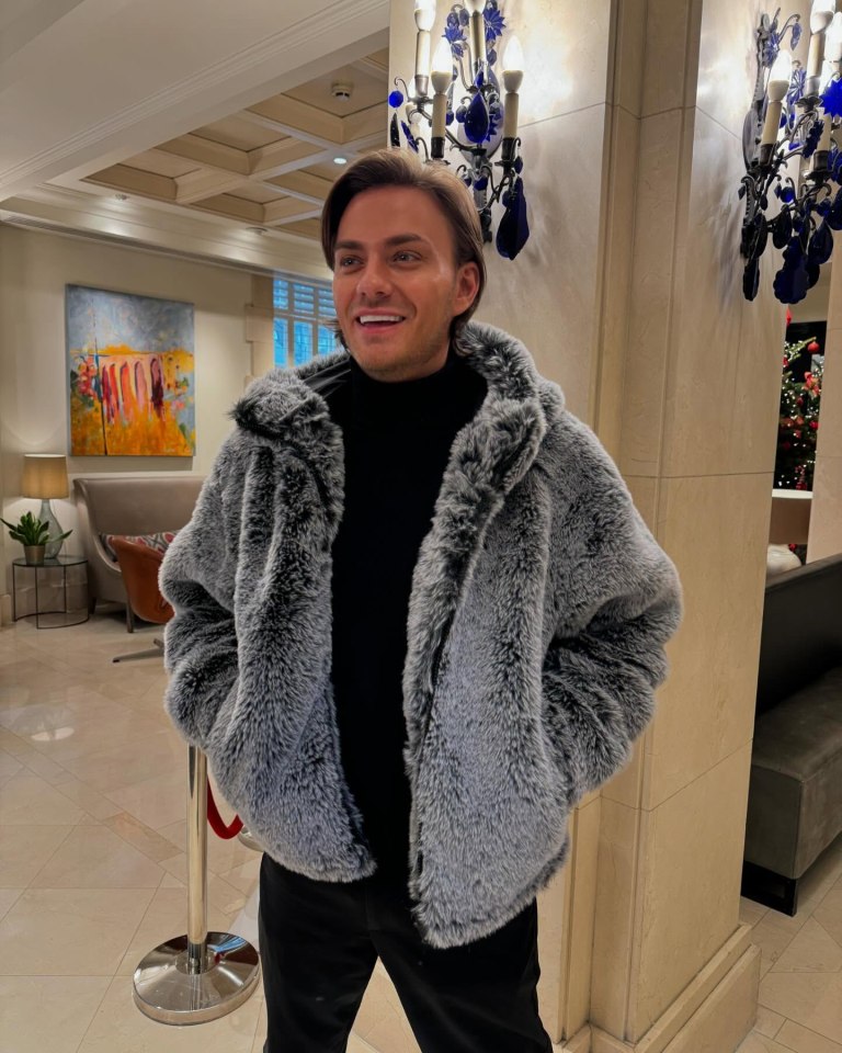 Freddie Bentley wearing a gray faux fur jacket.