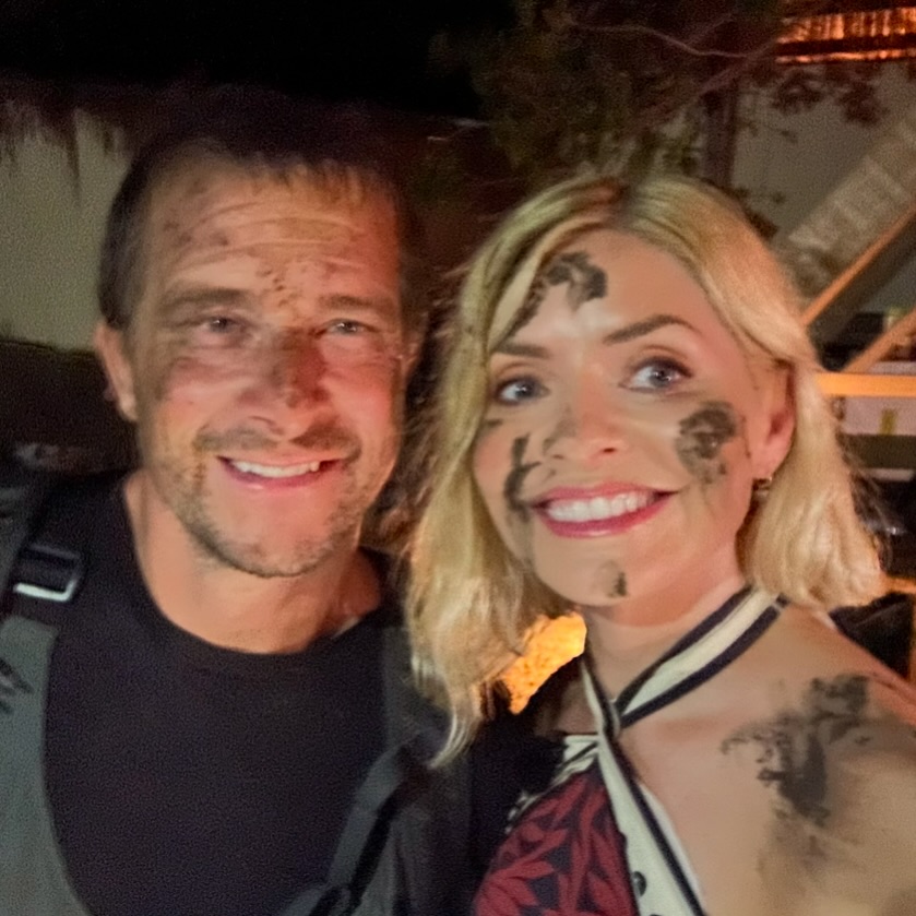 Holly Willoughby and Bear Grylls covered in mud.