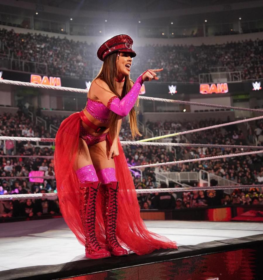 Chelsea Green, WWE wrestler, in a ring, pointing.