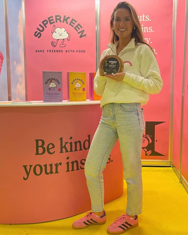 Woman holding award for Superkeen food brand.