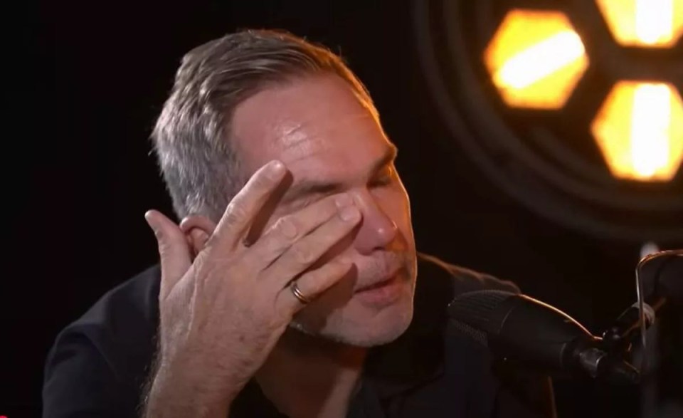 Man wiping tears from his eyes.