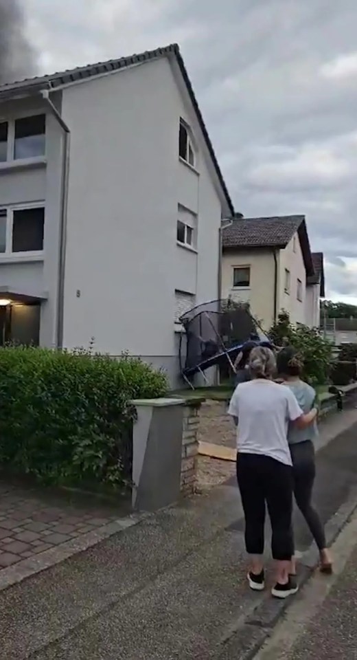 Man escaping burning building by jumping onto a trampoline.
