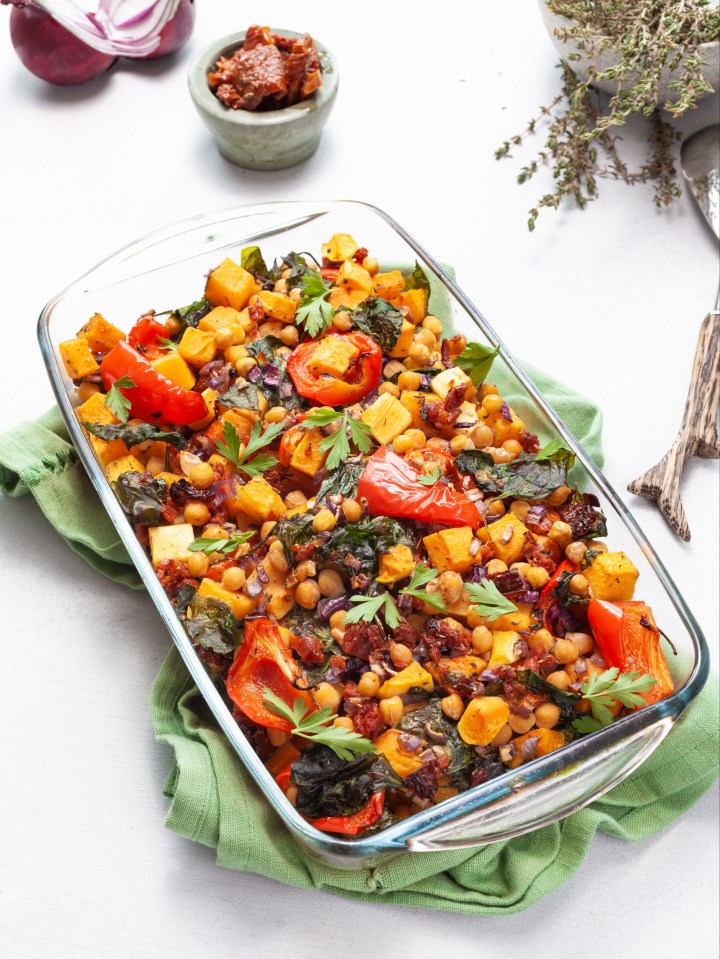 Roasted vegetable and chickpea dish in a glass baking dish.
