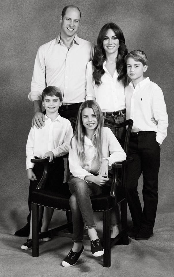 Black and white photo of the Prince and Princess of Wales with their three children.