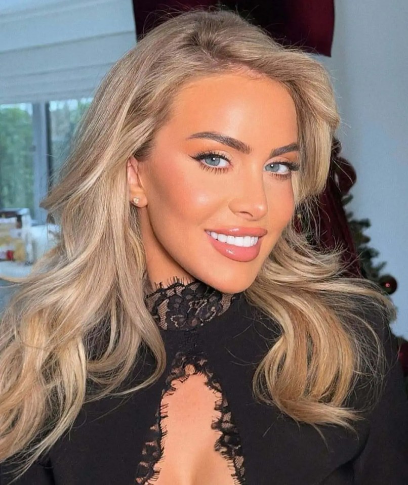 Woman with blonde hair and makeup wearing a black lace top.