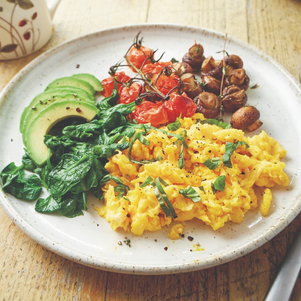 Scrambled eggs with roasted tomatoes, mushrooms, avocado, and spinach.