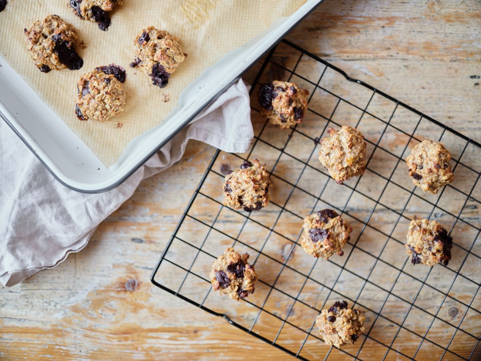 Three-ingredient oat bites on a baking sheet and cooling rack.