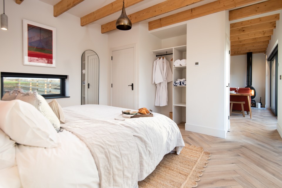 Bedroom with a bed, breakfast tray, and view.