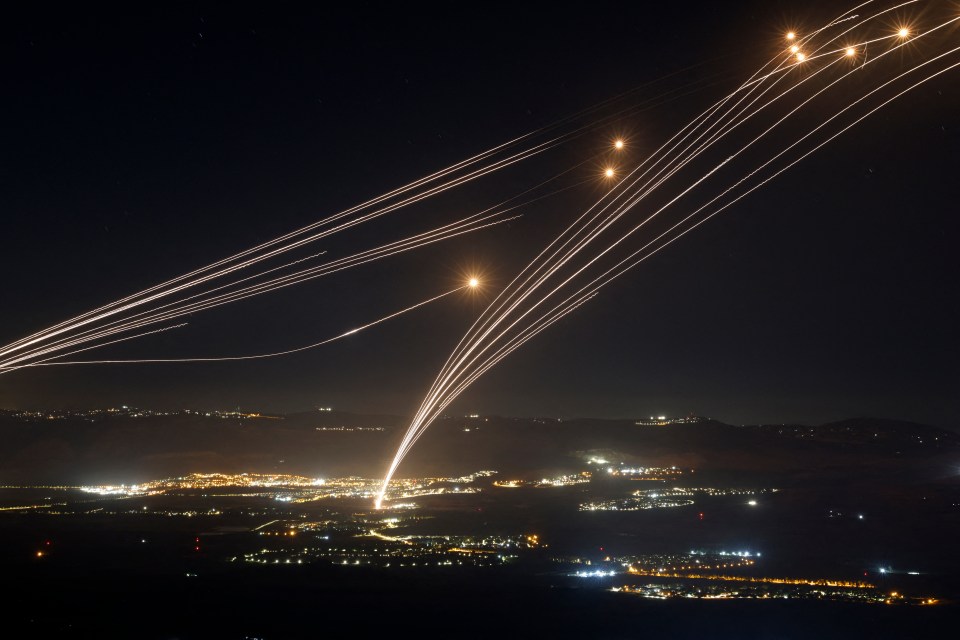 Rockets intercepted by Israel's Iron Dome air defense system over northern Israel at night.