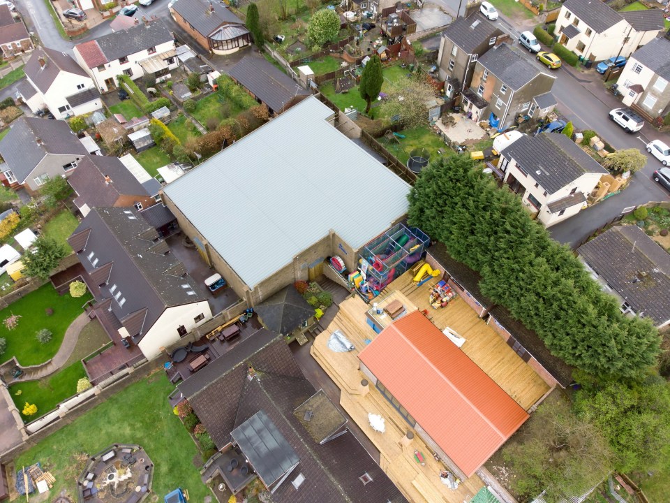 Aerial view of a large leisure complex and swimming pool in a residential area.