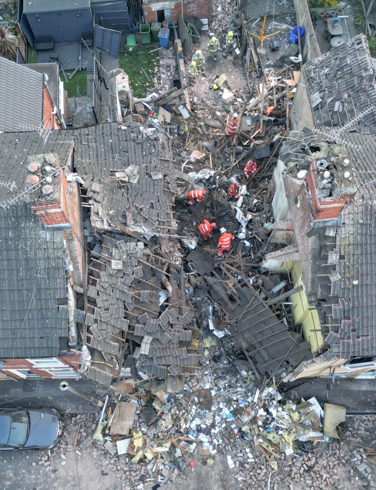 Aerial view of emergency responders at the site of a house explosion.