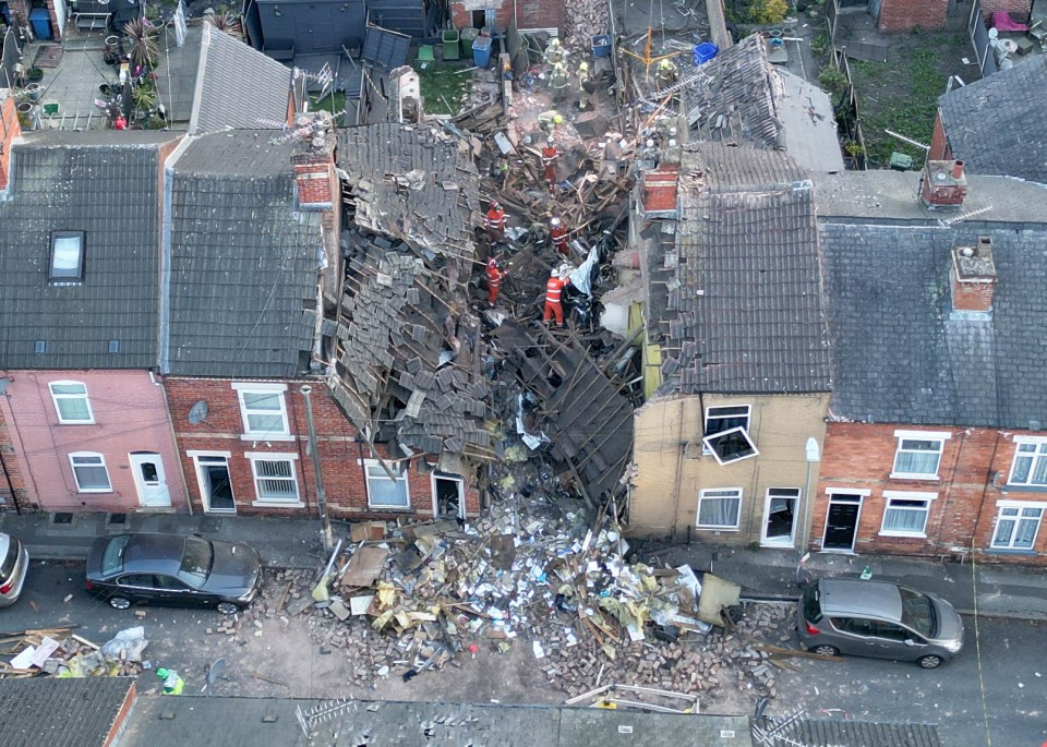 Aerial view of emergency responders at the site of a house explosion.