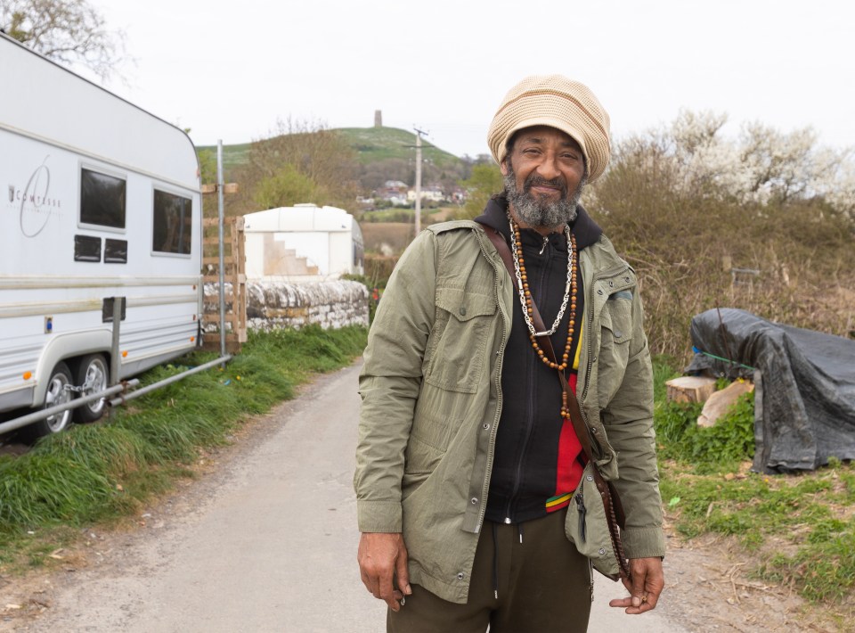 A musician standing outside his van in Glastonbury, Somerset.