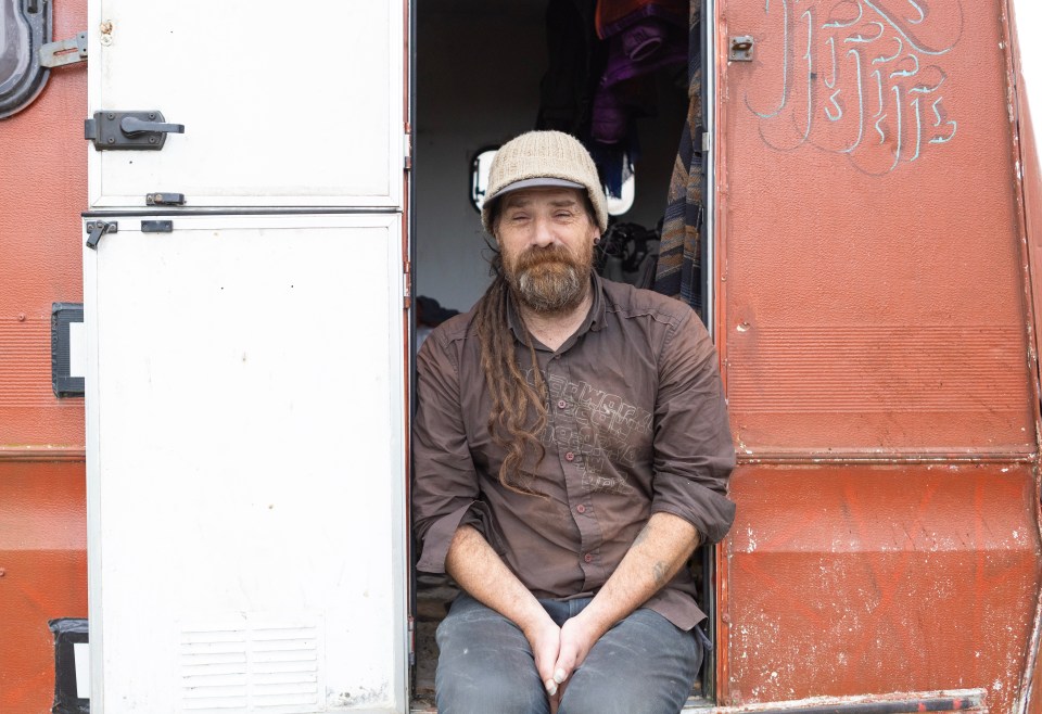 Unemployed man sitting in his van.