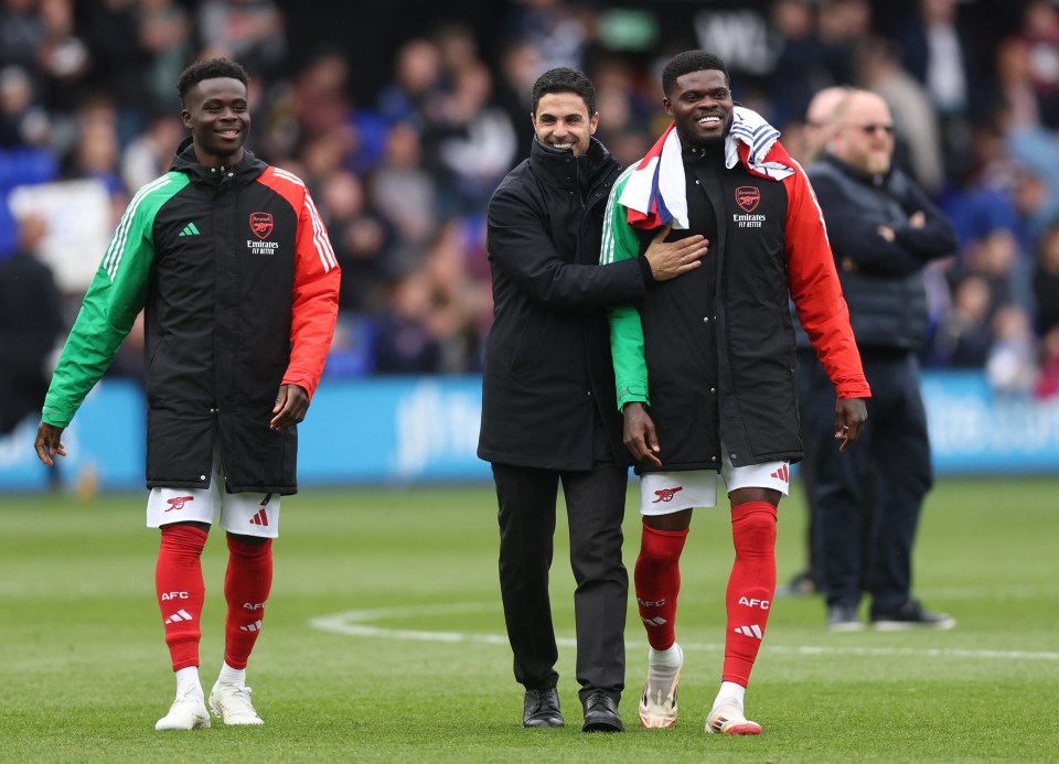Mikel Arteta with Bukayo Saka and Thomas Partey after a soccer match.