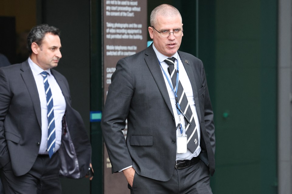 Two men in suits leaving a courthouse.